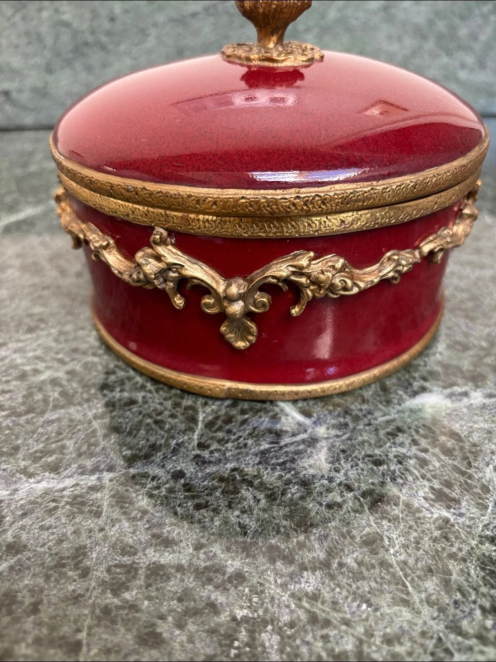 vintage porcelain trinket box with an ornate brass rim